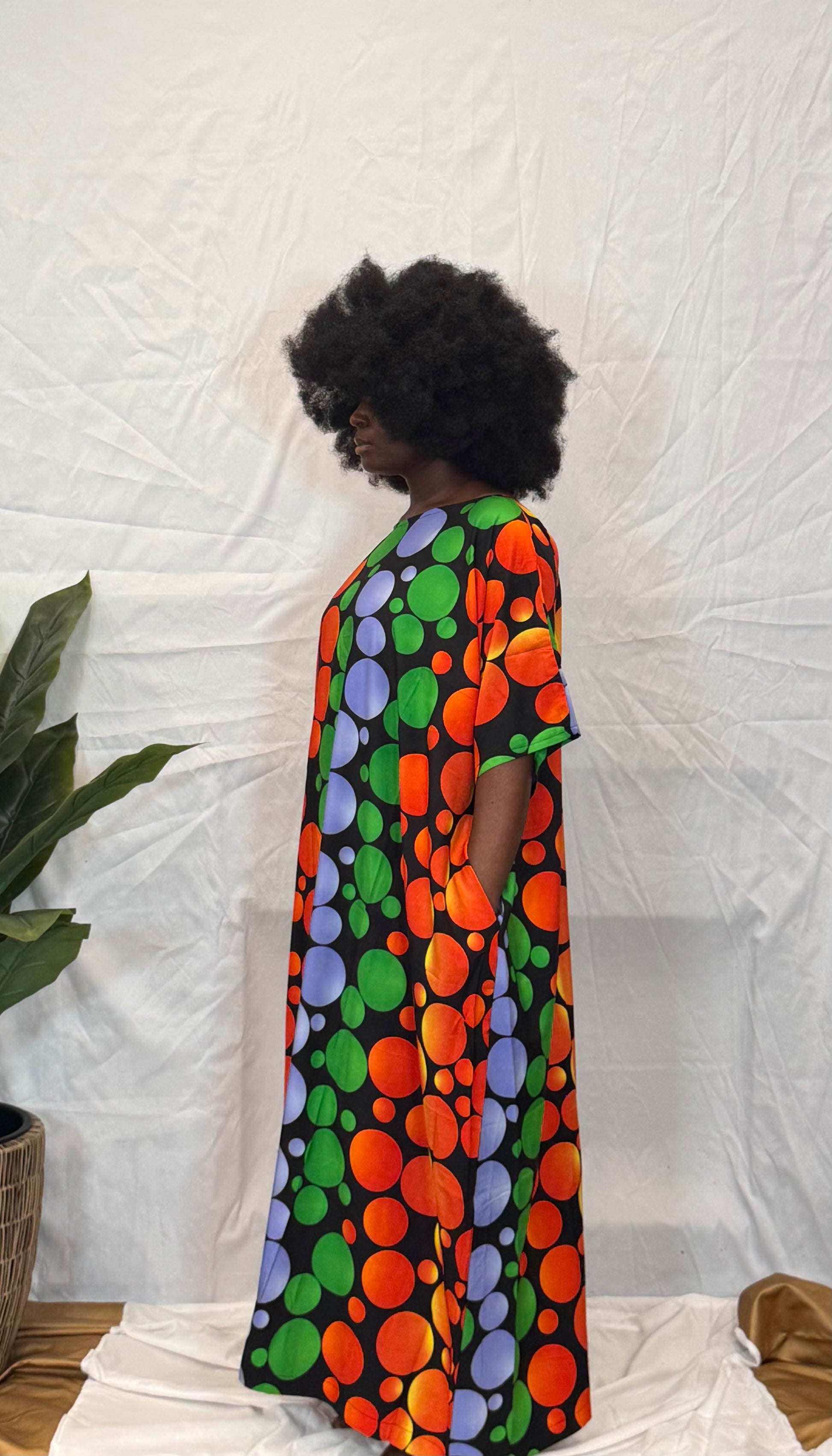 Black woman wearing bright colorful kaftan