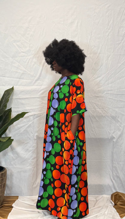 Black woman wearing bright colorful kaftan