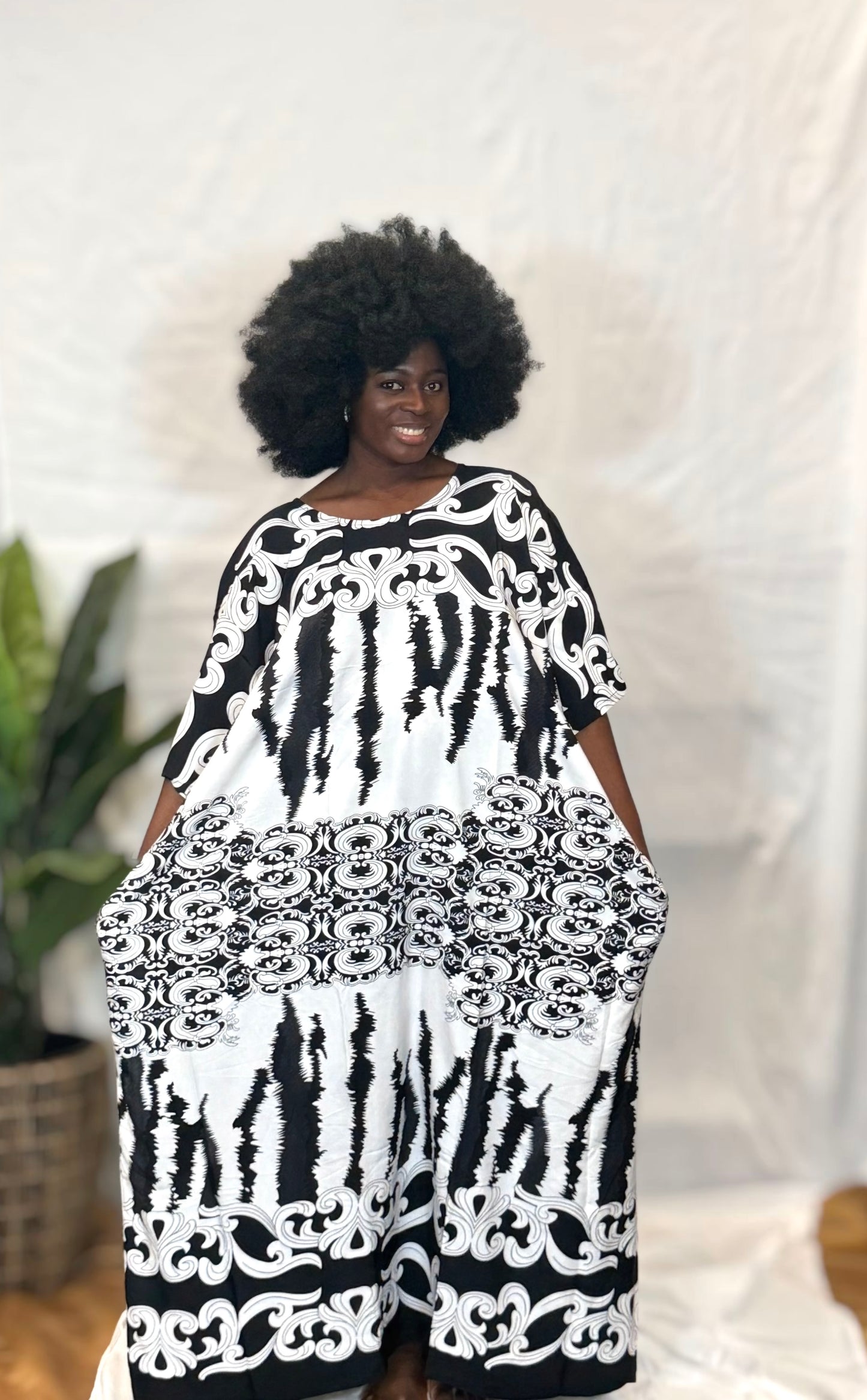 Black woman wearing bright colorful kaftan