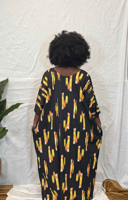 Black woman wearing bright colorful kaftan