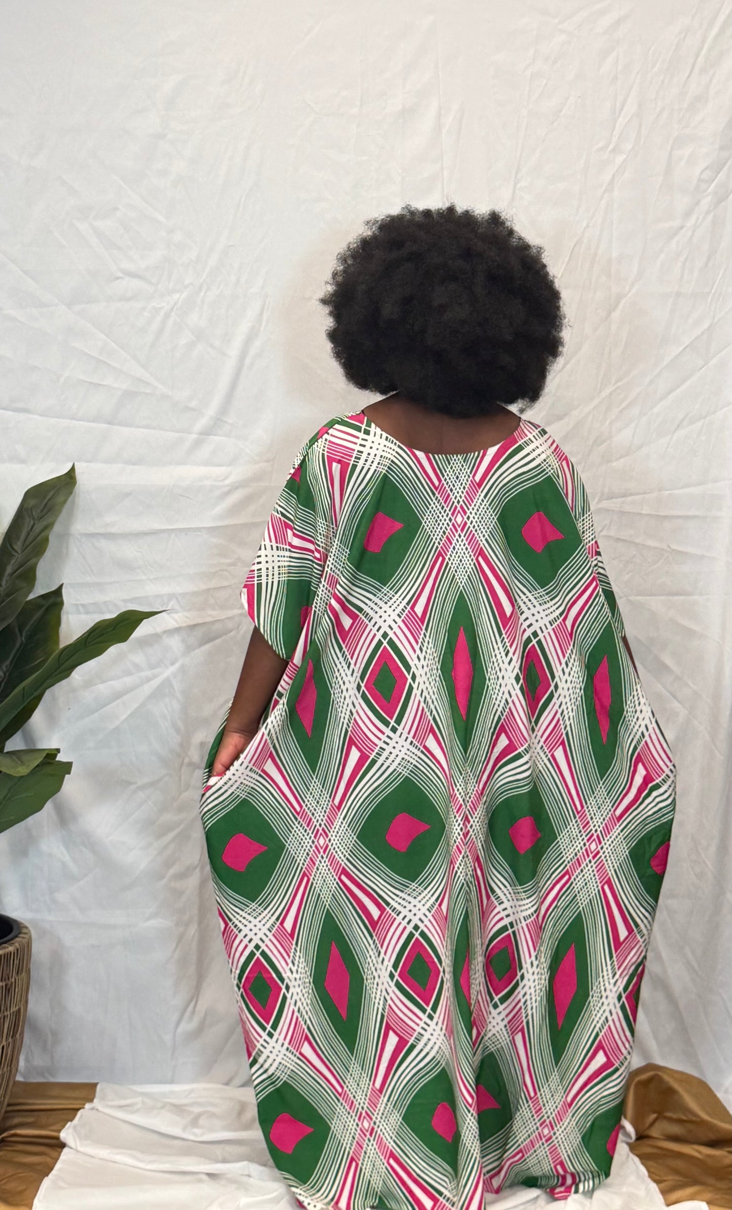 Black woman wearing bright colorful kaftan