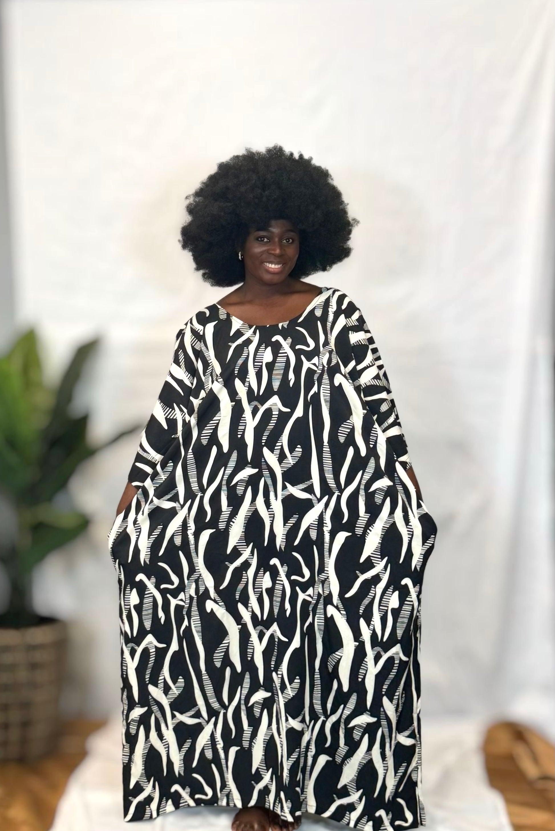 Black woman wearing bright colorful kaftan
