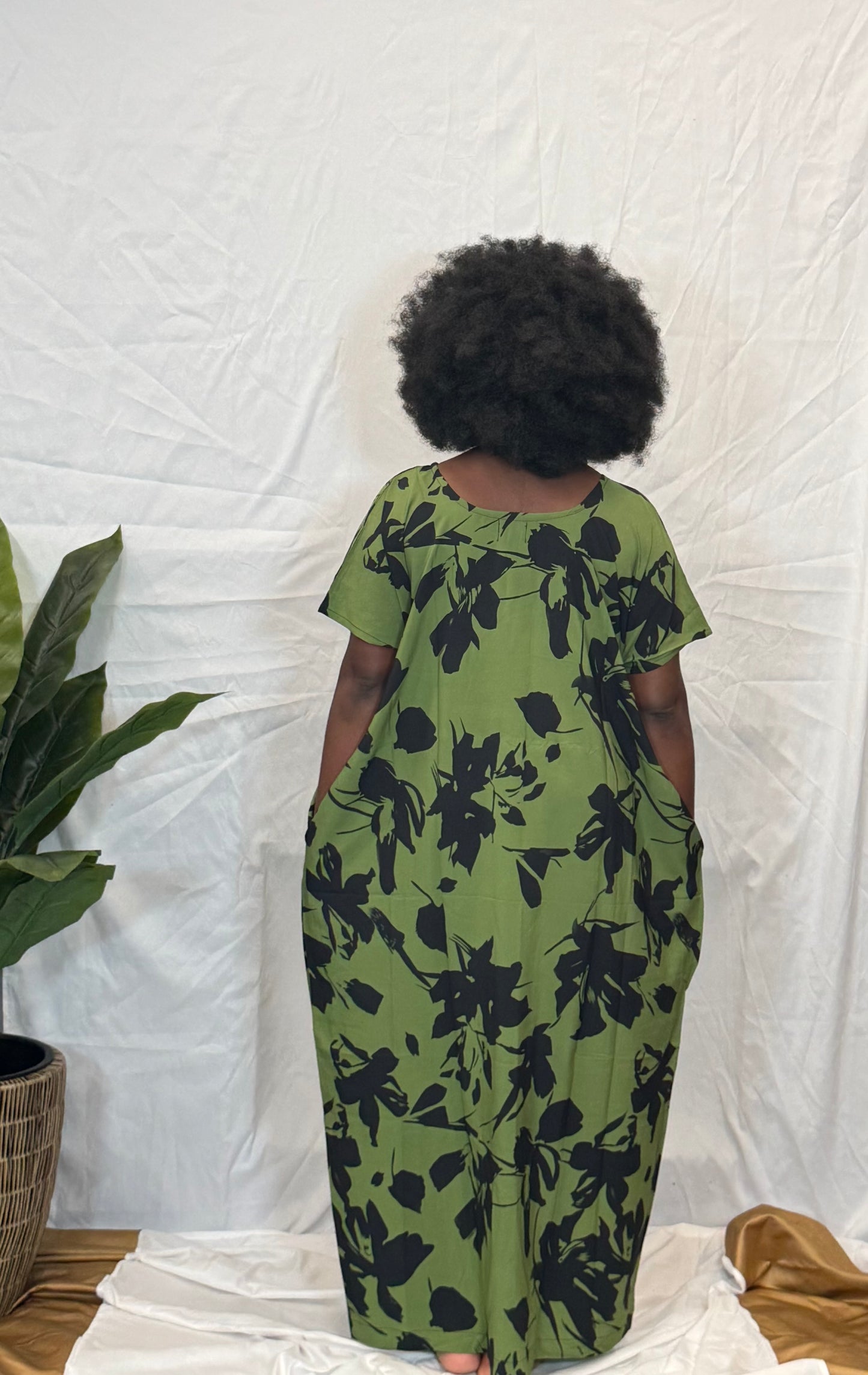 Black woman wearing bright colorful kaftan