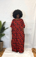 Black woman wearing bright colorful kaftan