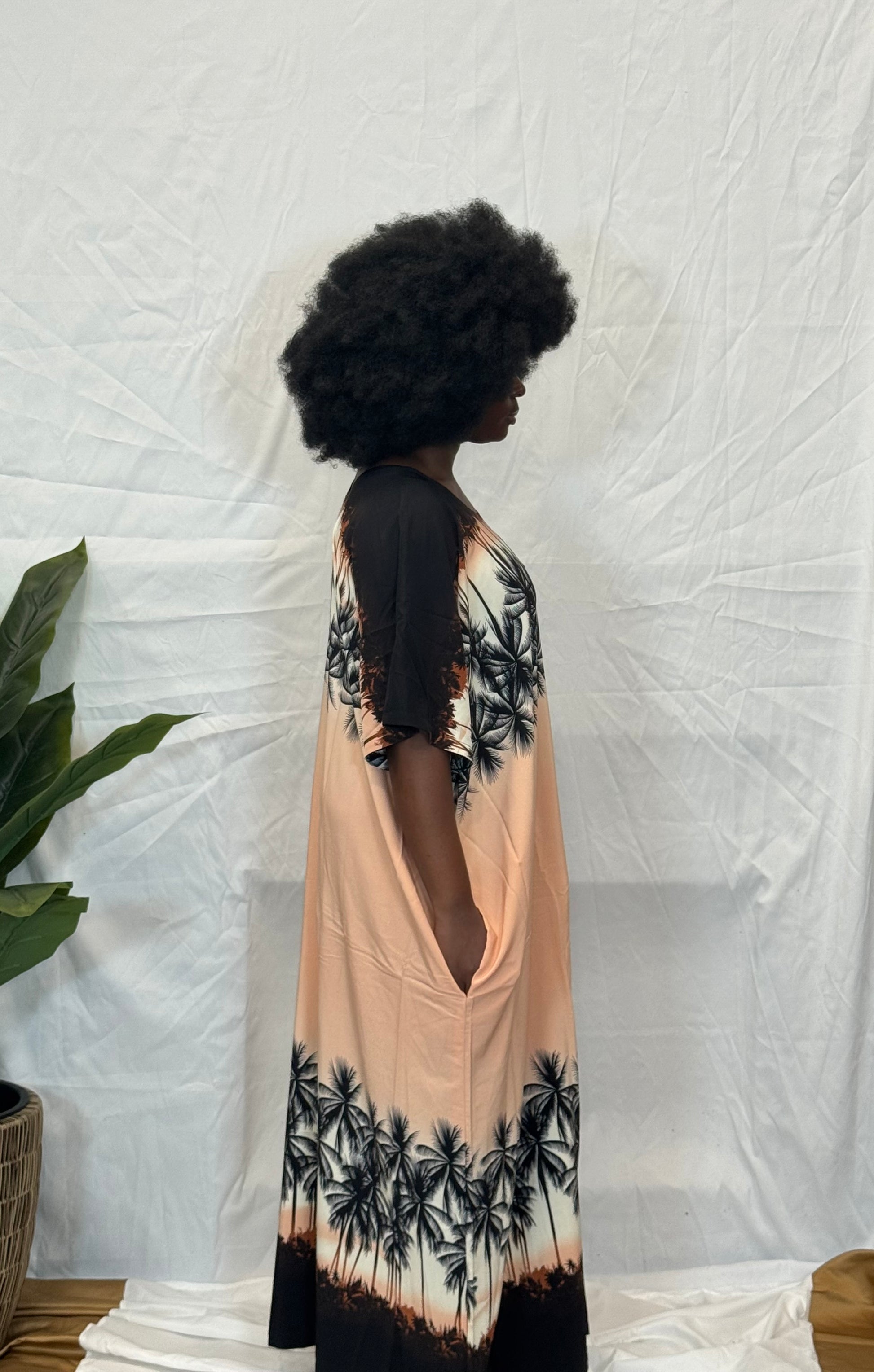 Black woman wearing bright colorful kaftan