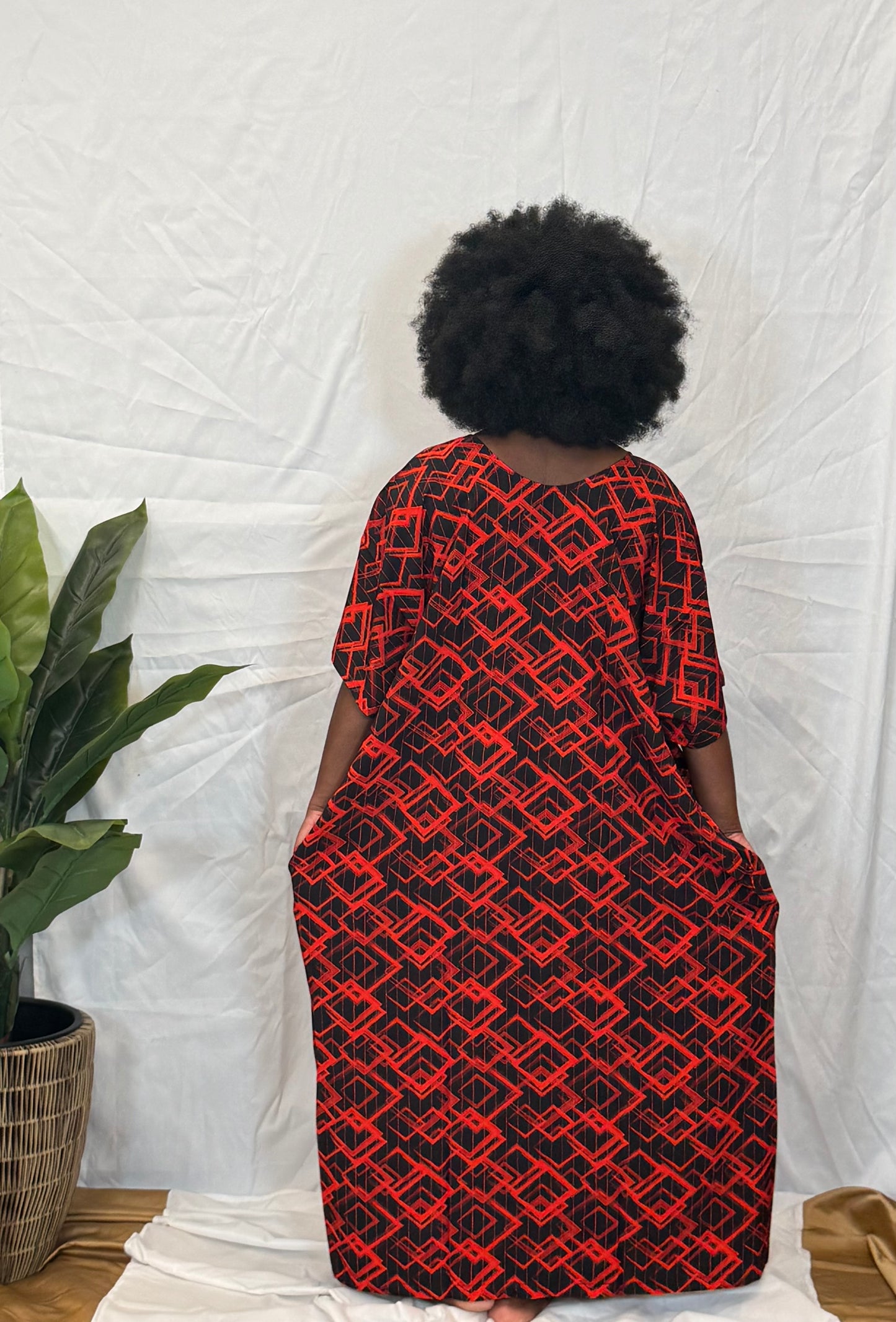 Black woman wearing bright colorful kaftan