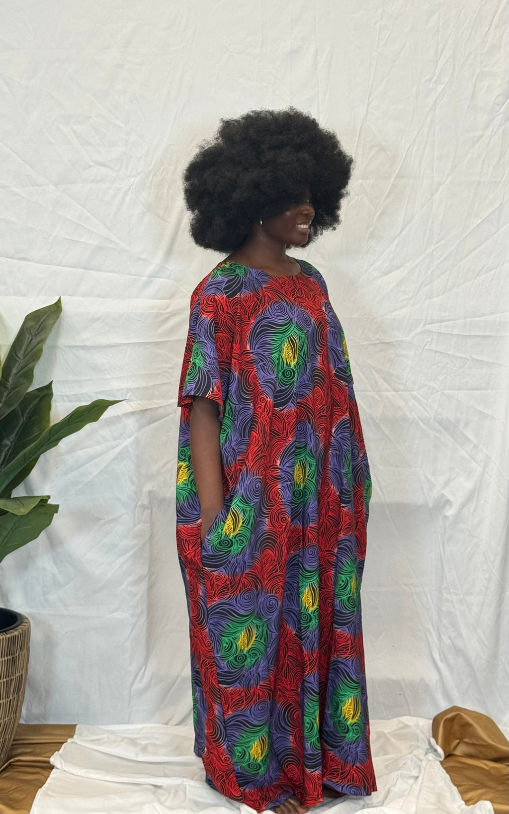 Black woman wearing bright colorful kaftan