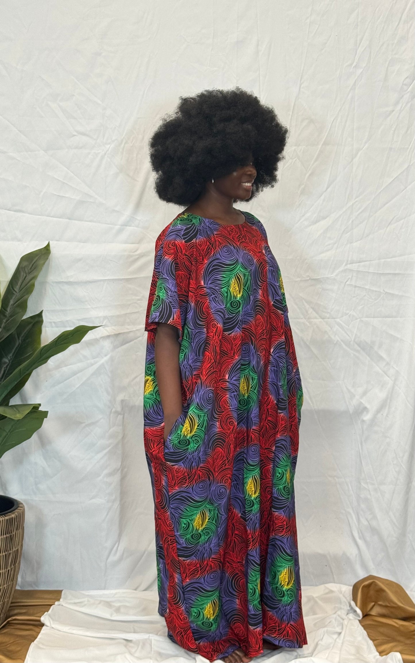 Black woman wearing bright colorful kaftan
