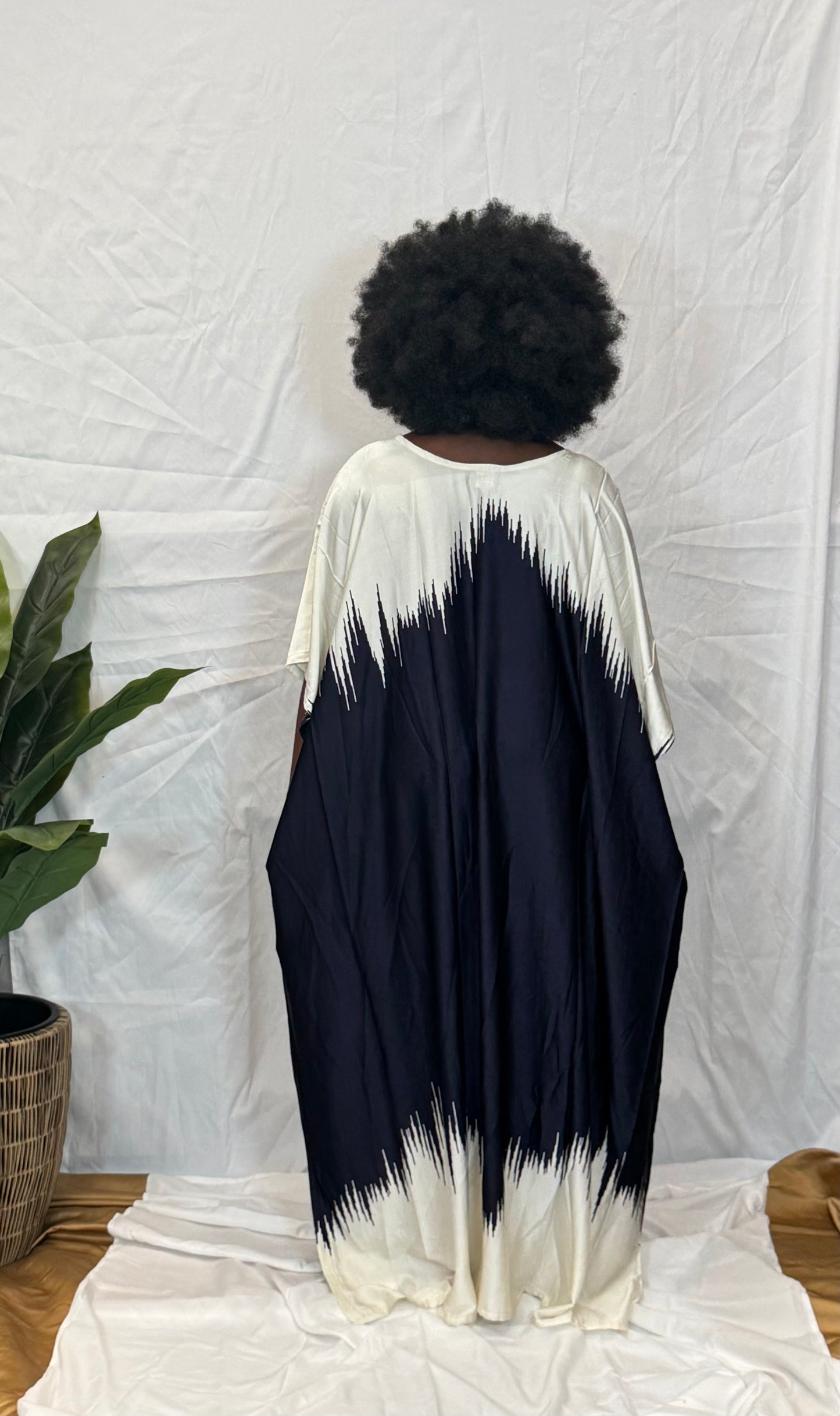 Black woman wearing bright colorful kaftan