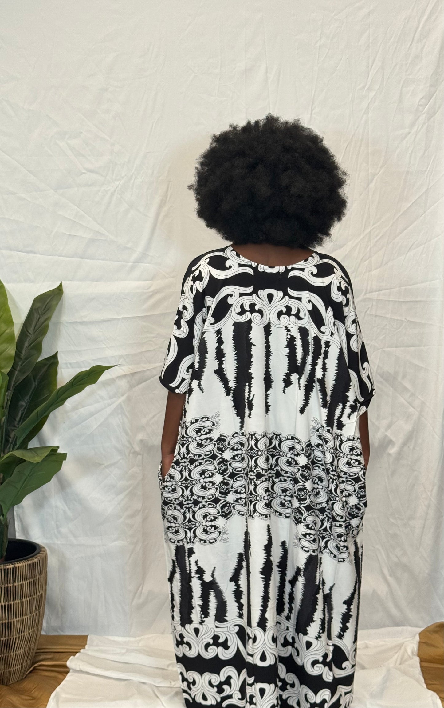 Black woman wearing bright colorful kaftan