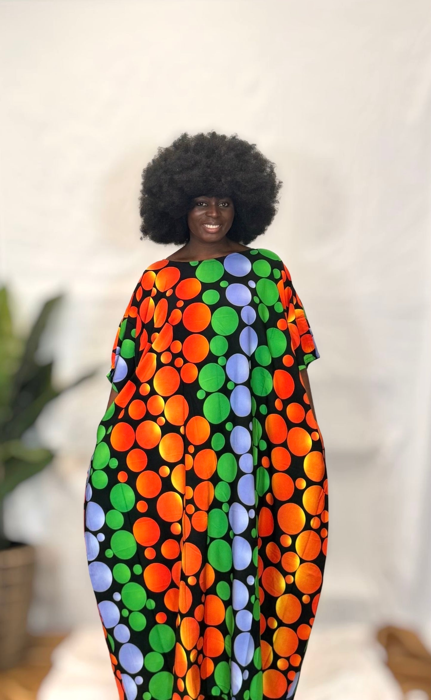Black woman wearing bright colorful kaftan