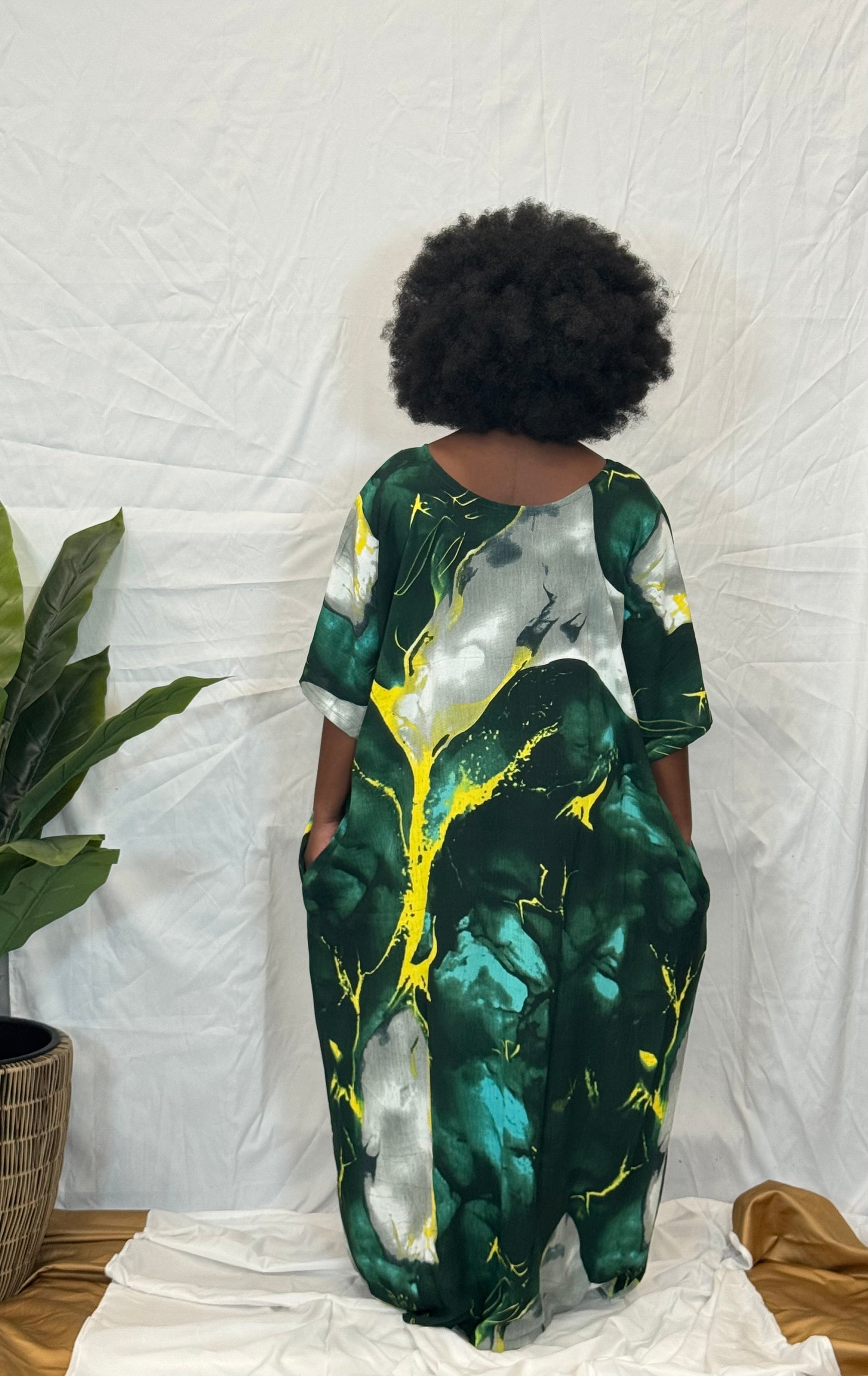 Black woman wearing bright colorful kaftan