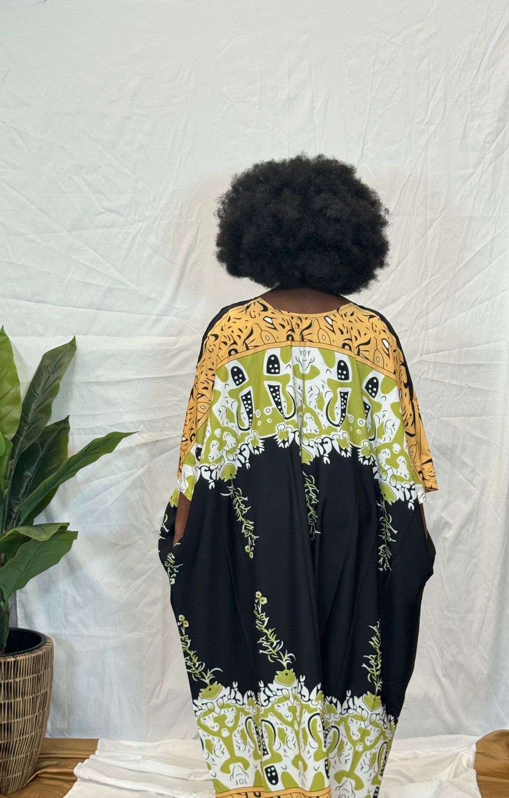 Black woman wearing colorful kaftan 