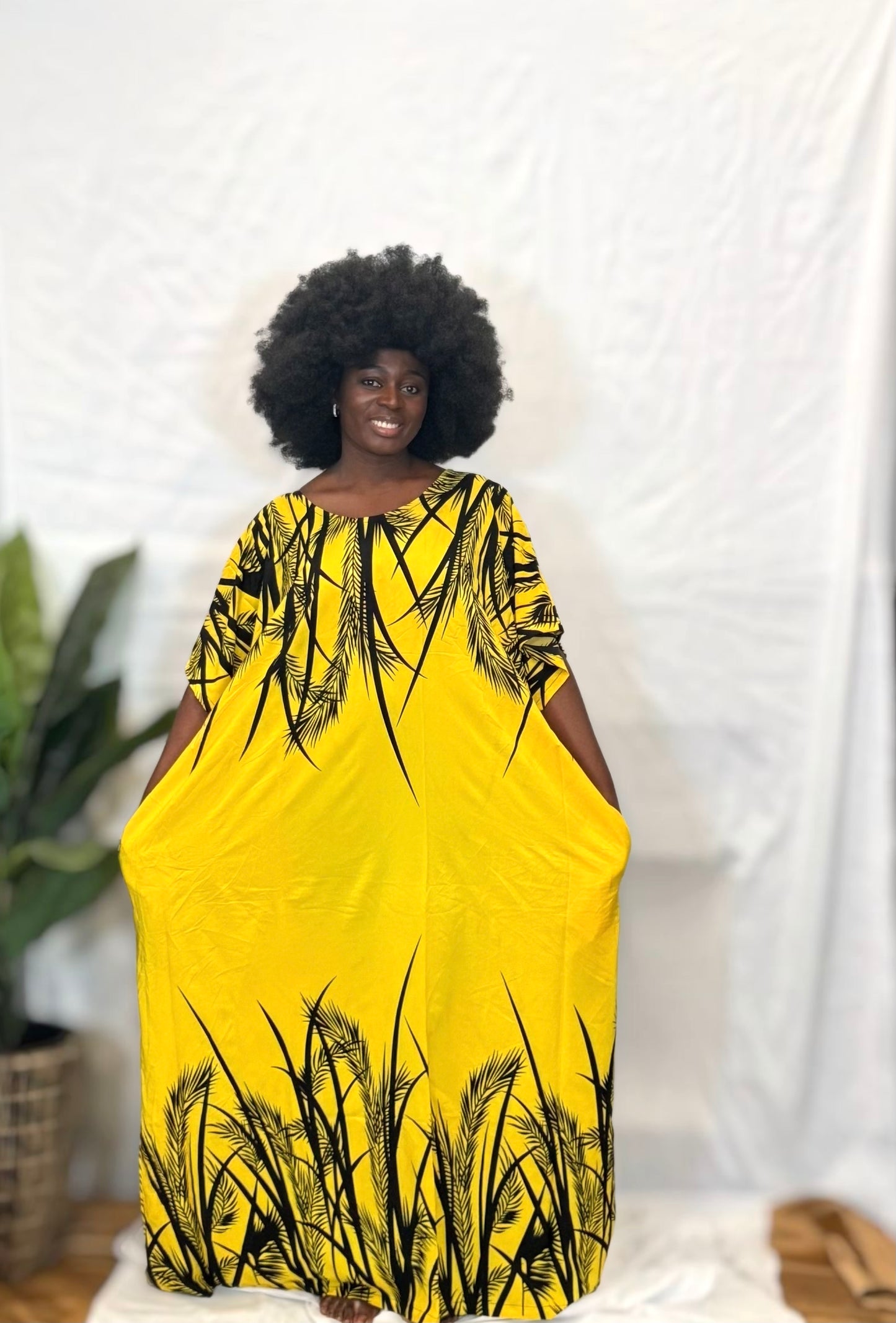 Black woman wearing bright colorful kaftan