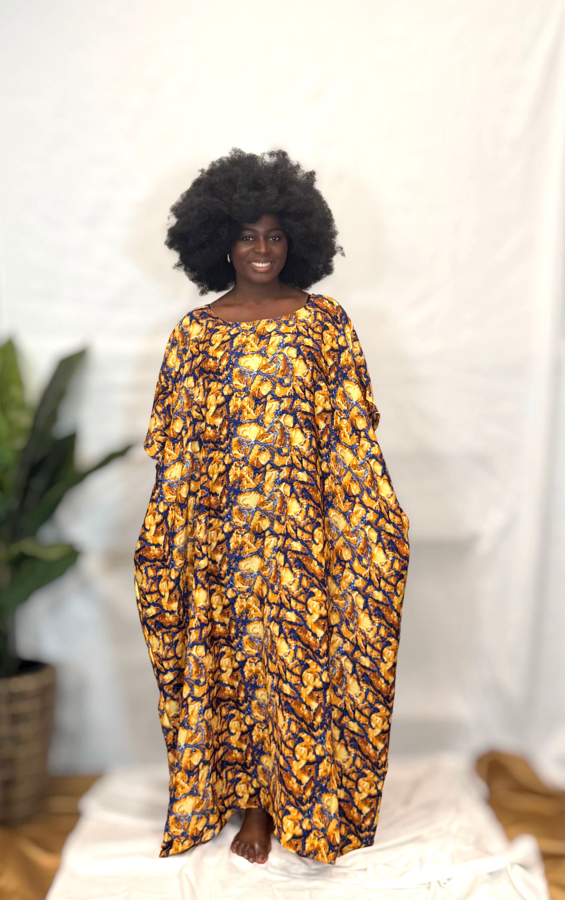 Black woman wearing bright colorful kaftan