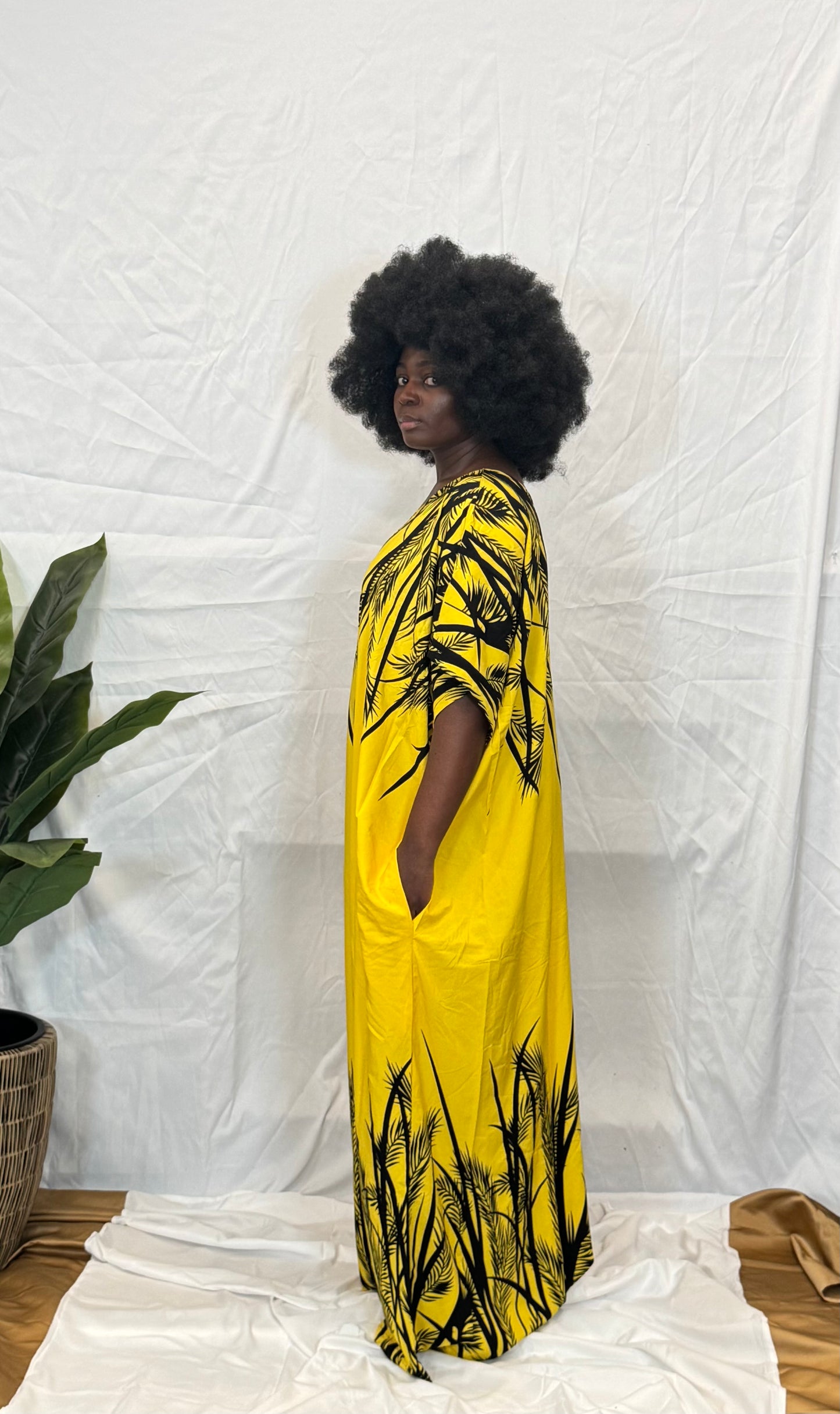 Black woman wearing bright colorful kaftan