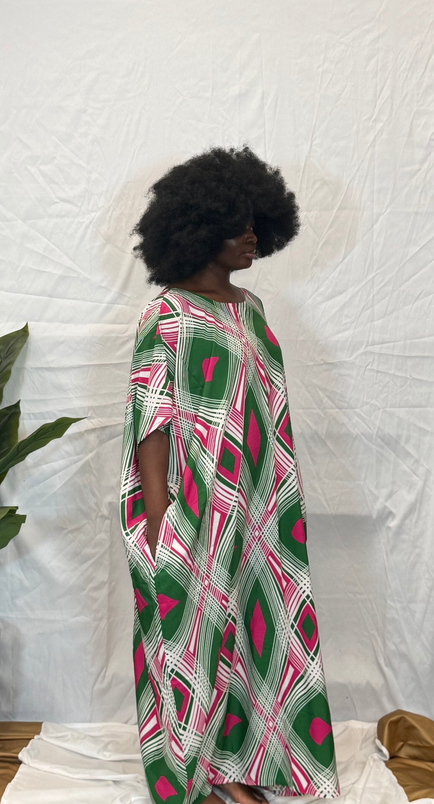 Black woman wearing bright colorful kaftan