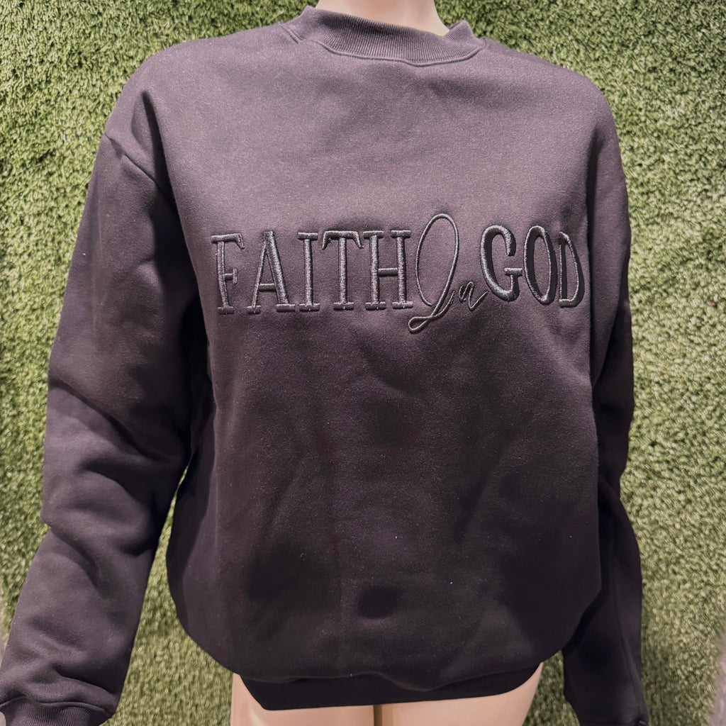 A black sweatshirt with 'FAITH IN GOD' embroidered on the chest.