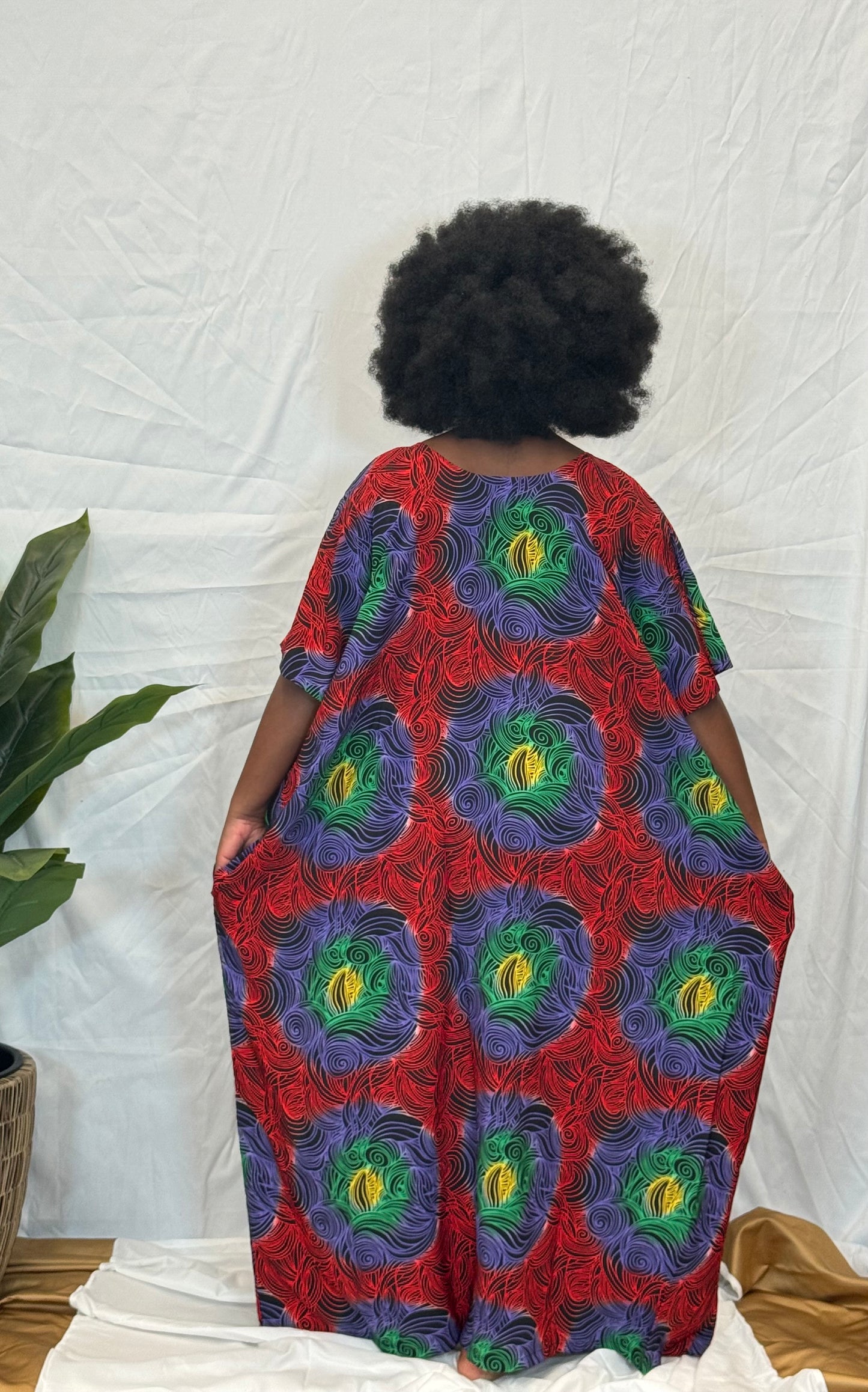 Black woman wearing bright colorful kaftan