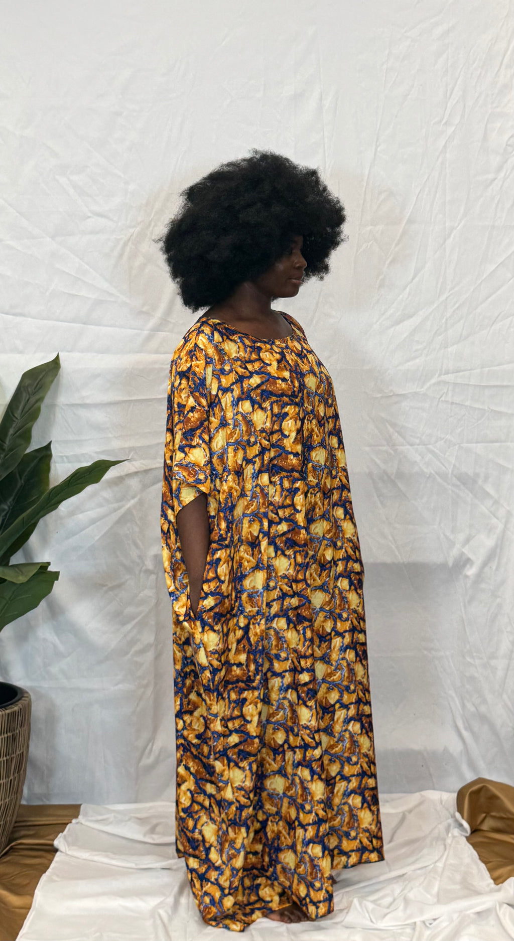 Black woman wearing bright colorful kaftan