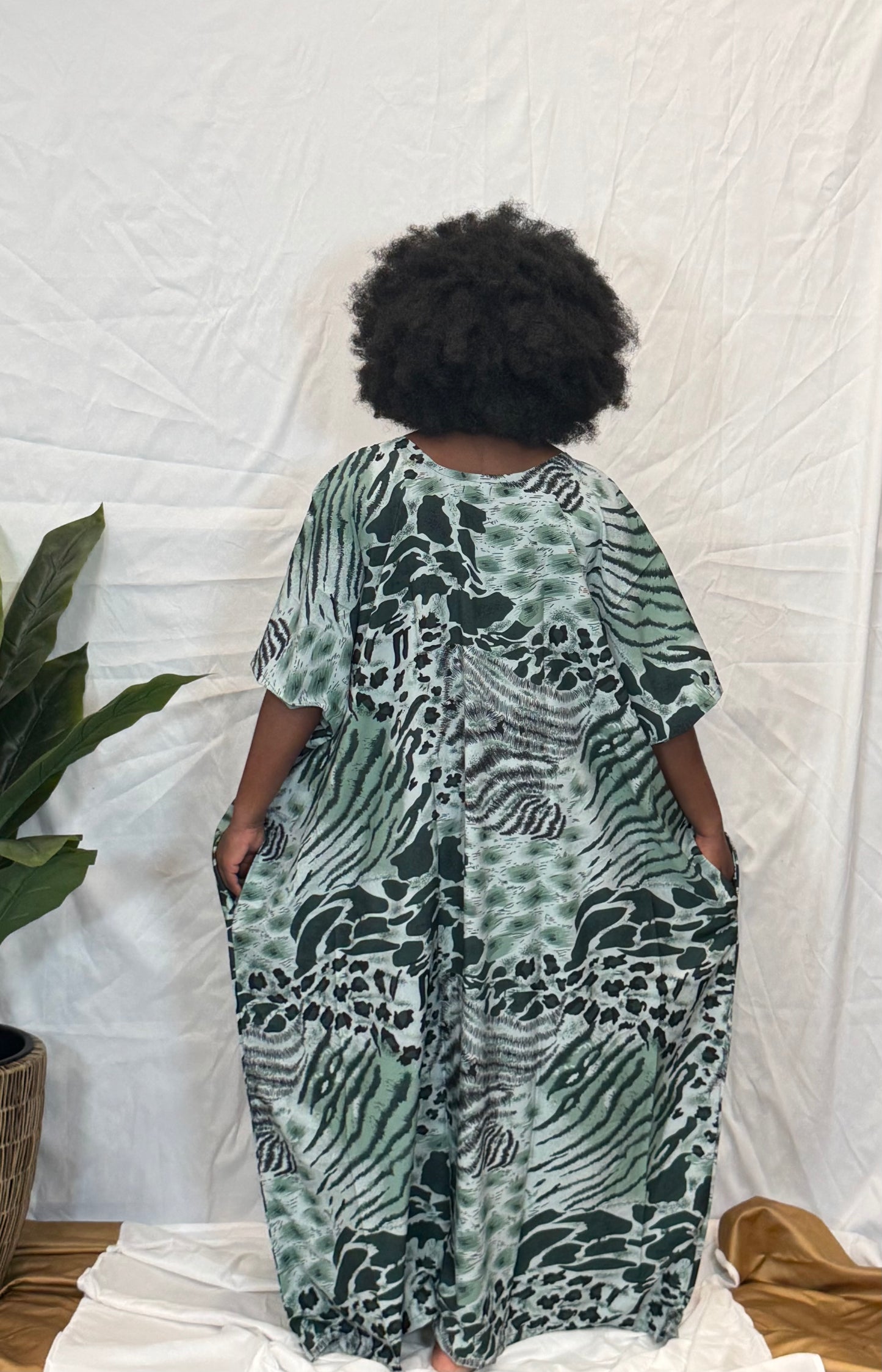 Black woman wearing bright colorful kaftan