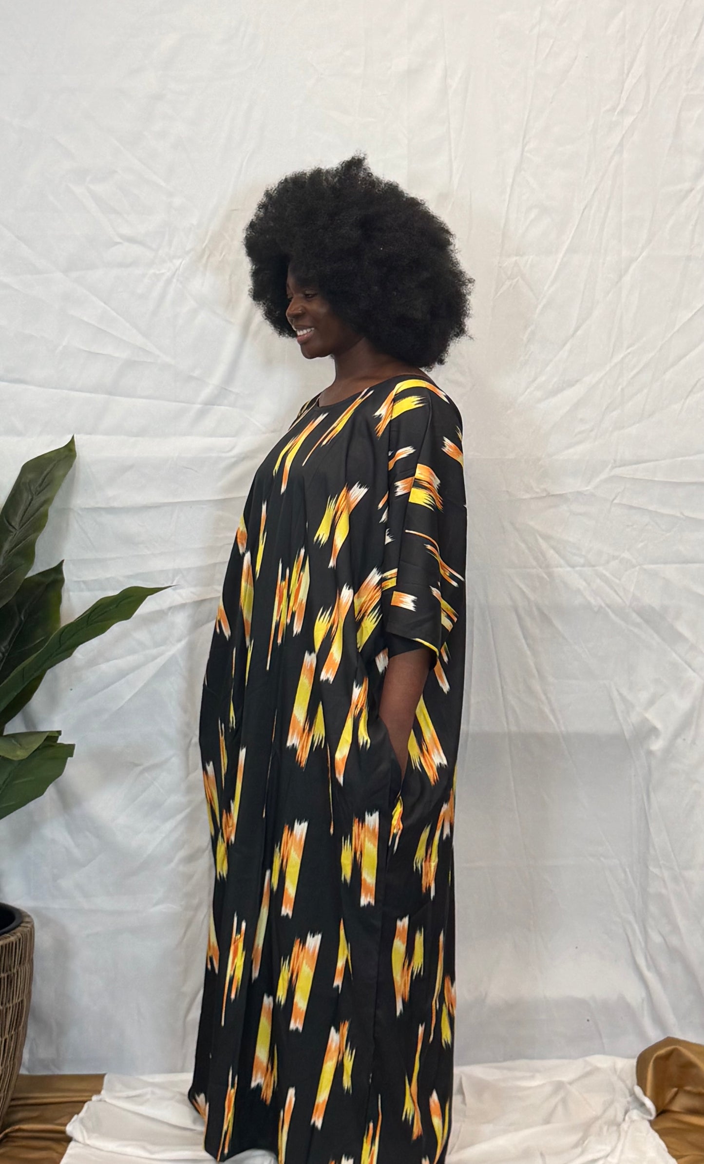 Black woman wearing bright colorful kaftan