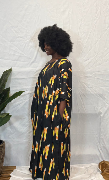 Black woman wearing bright colorful kaftan