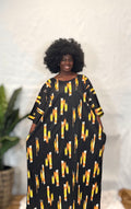 Black woman wearing bright colorful kaftan