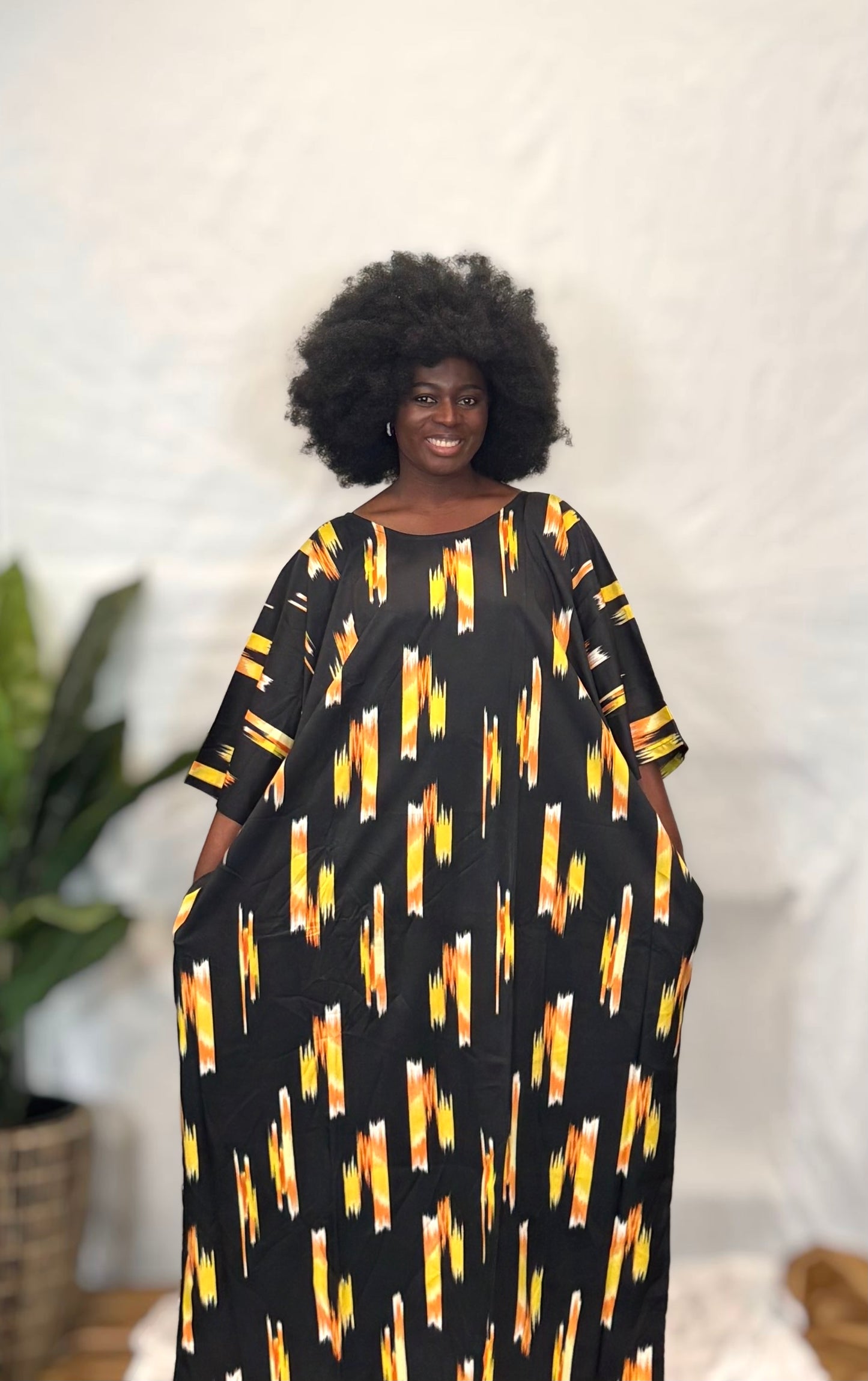 Black woman wearing bright colorful kaftan