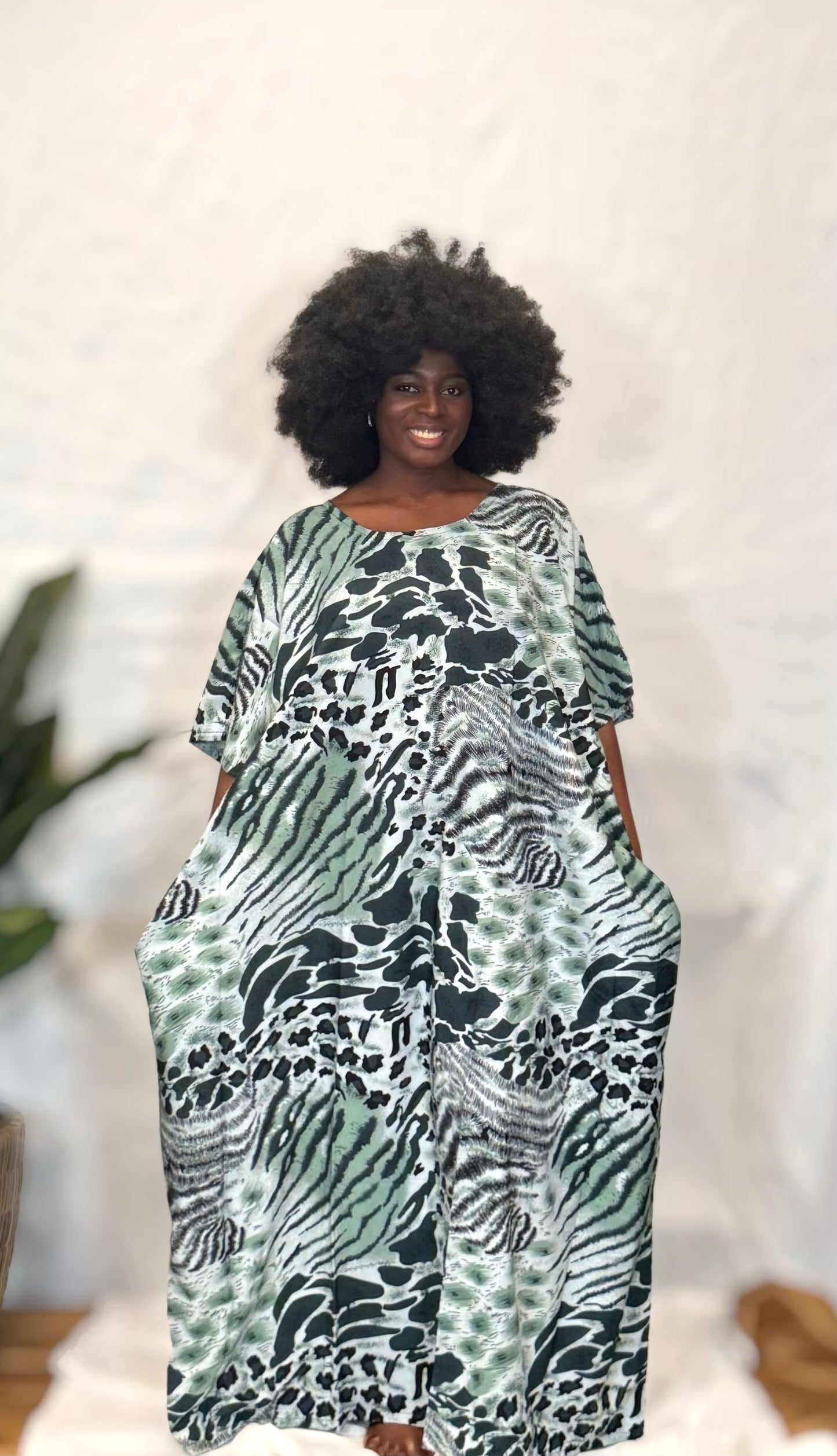 Black woman wearing bright colorful kaftan
