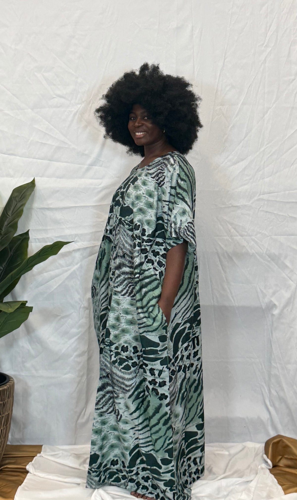 Black woman wearing bright colorful kaftan