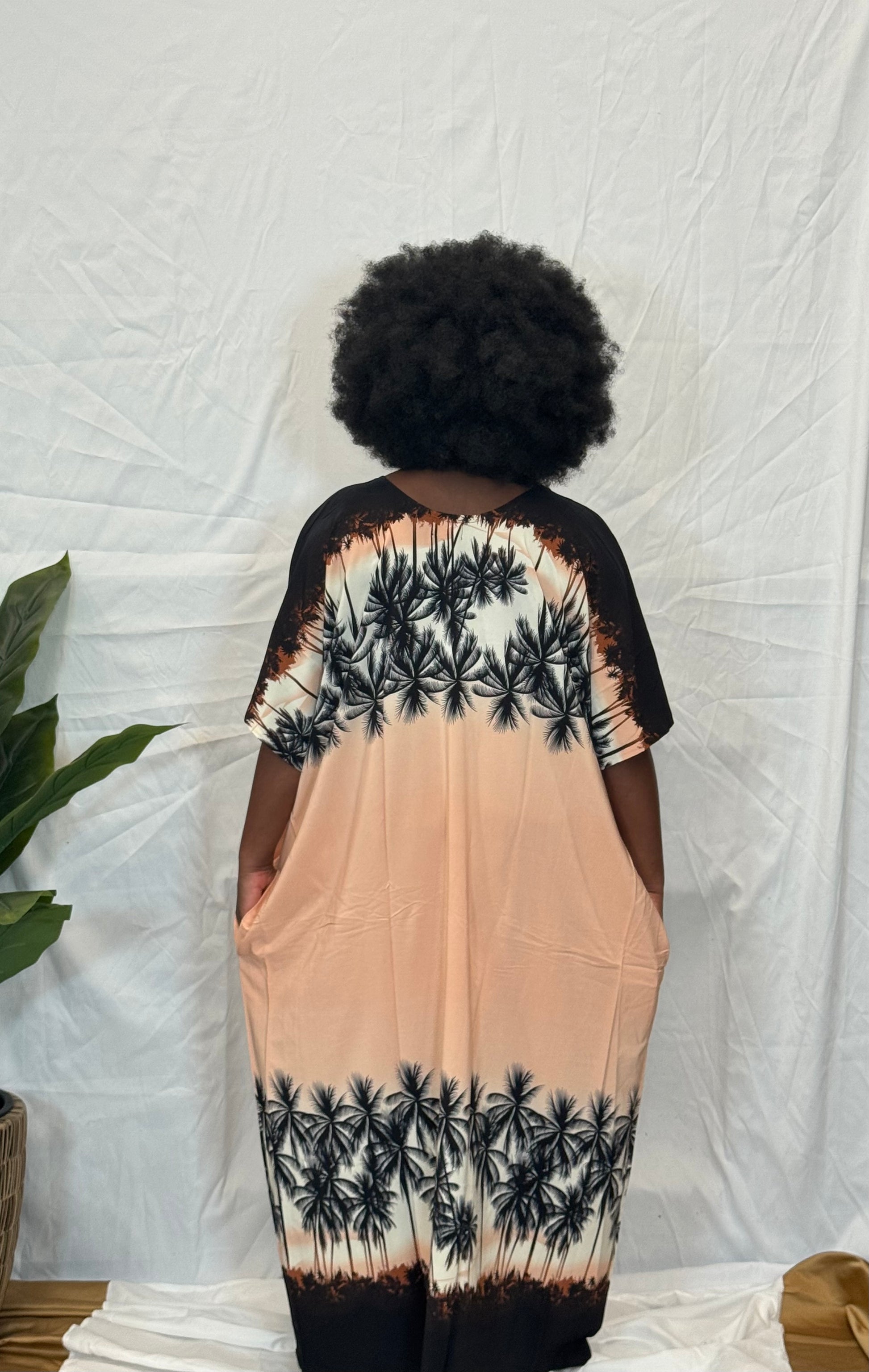 Black woman wearing bright colorful kaftan