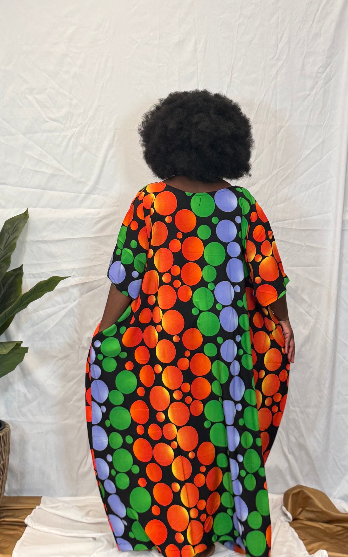 Black woman wearing bright colorful kaftan