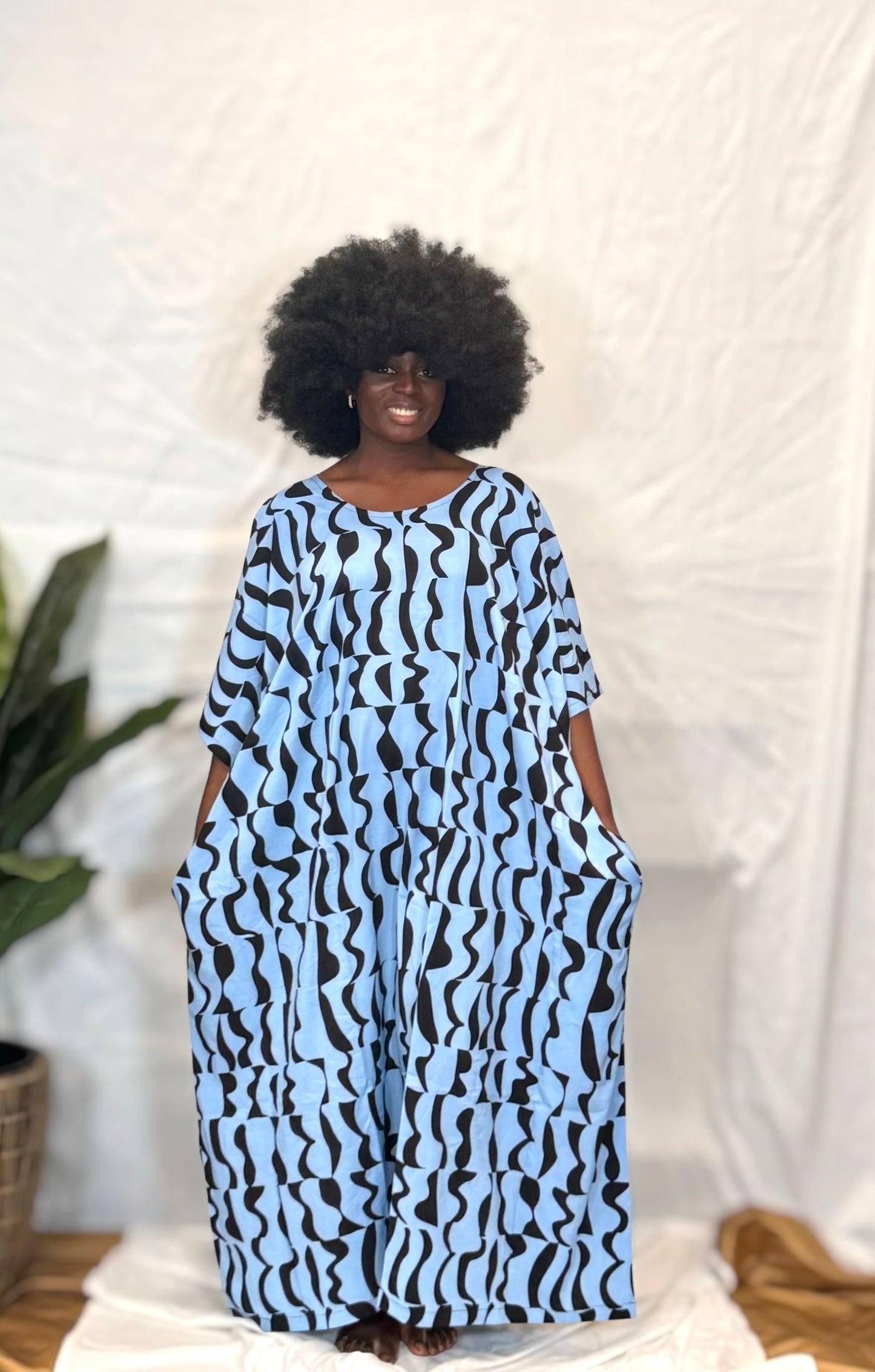 Black woman wearing bright colorful kaftan