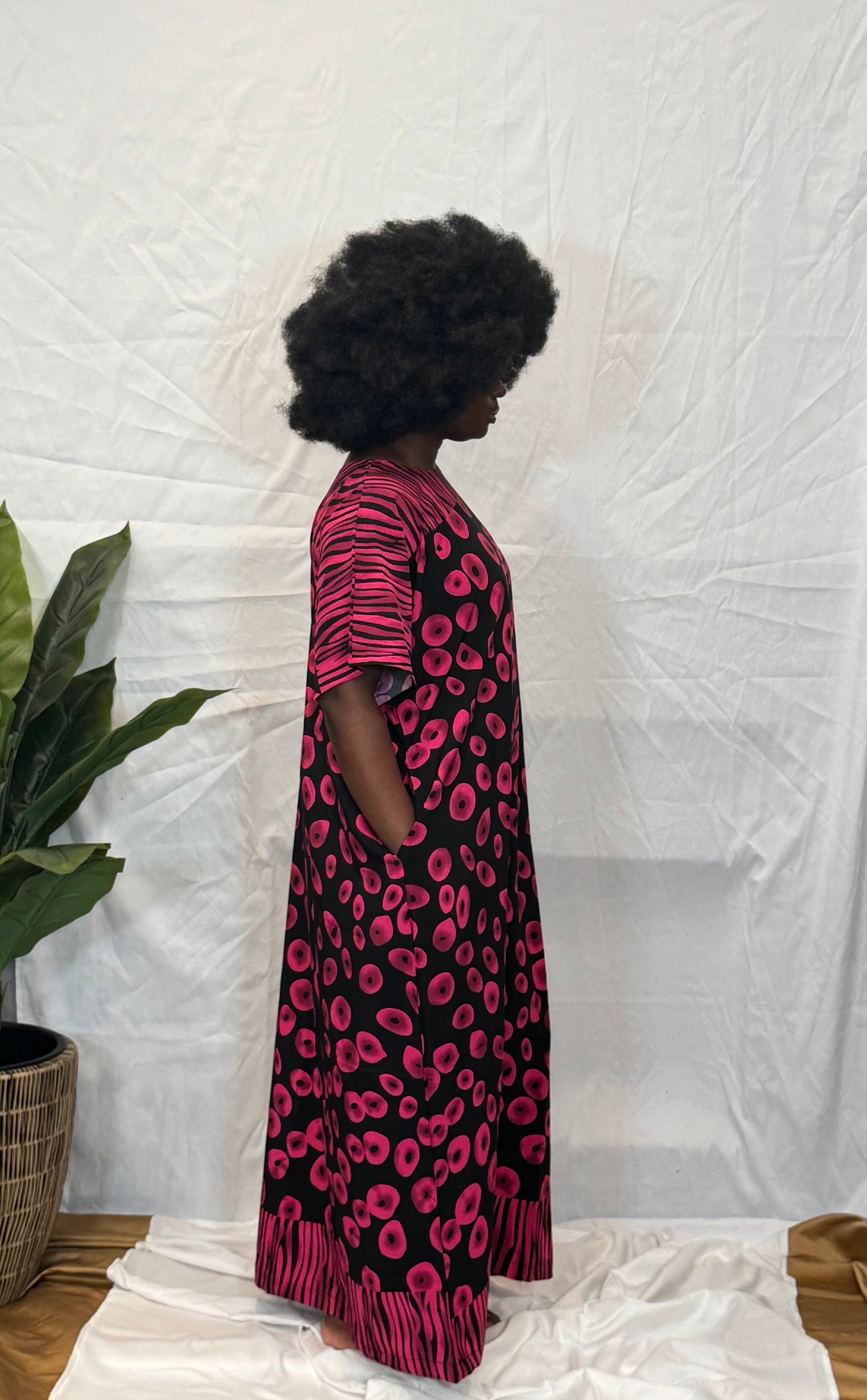 Black woman wearing bright colorful kaftan