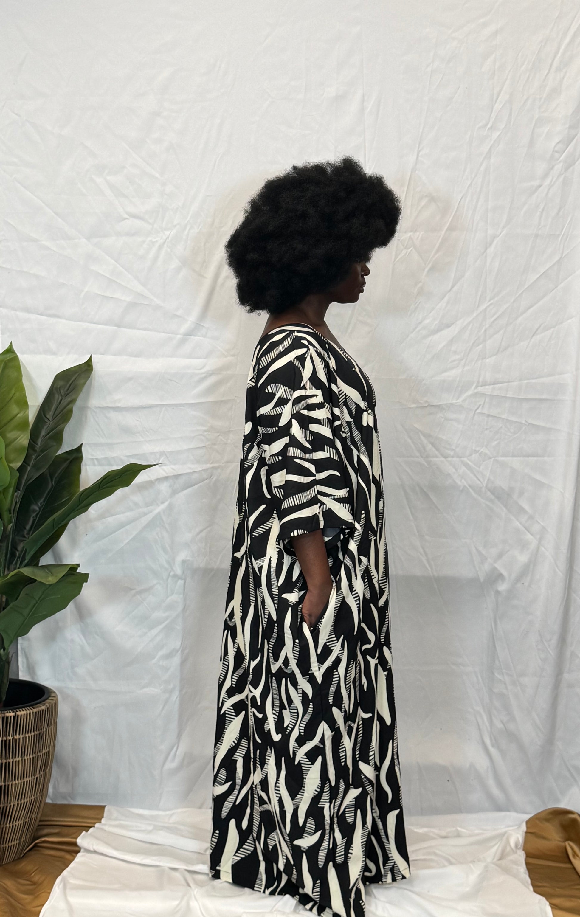 Black woman wearing bright colorful kaftan