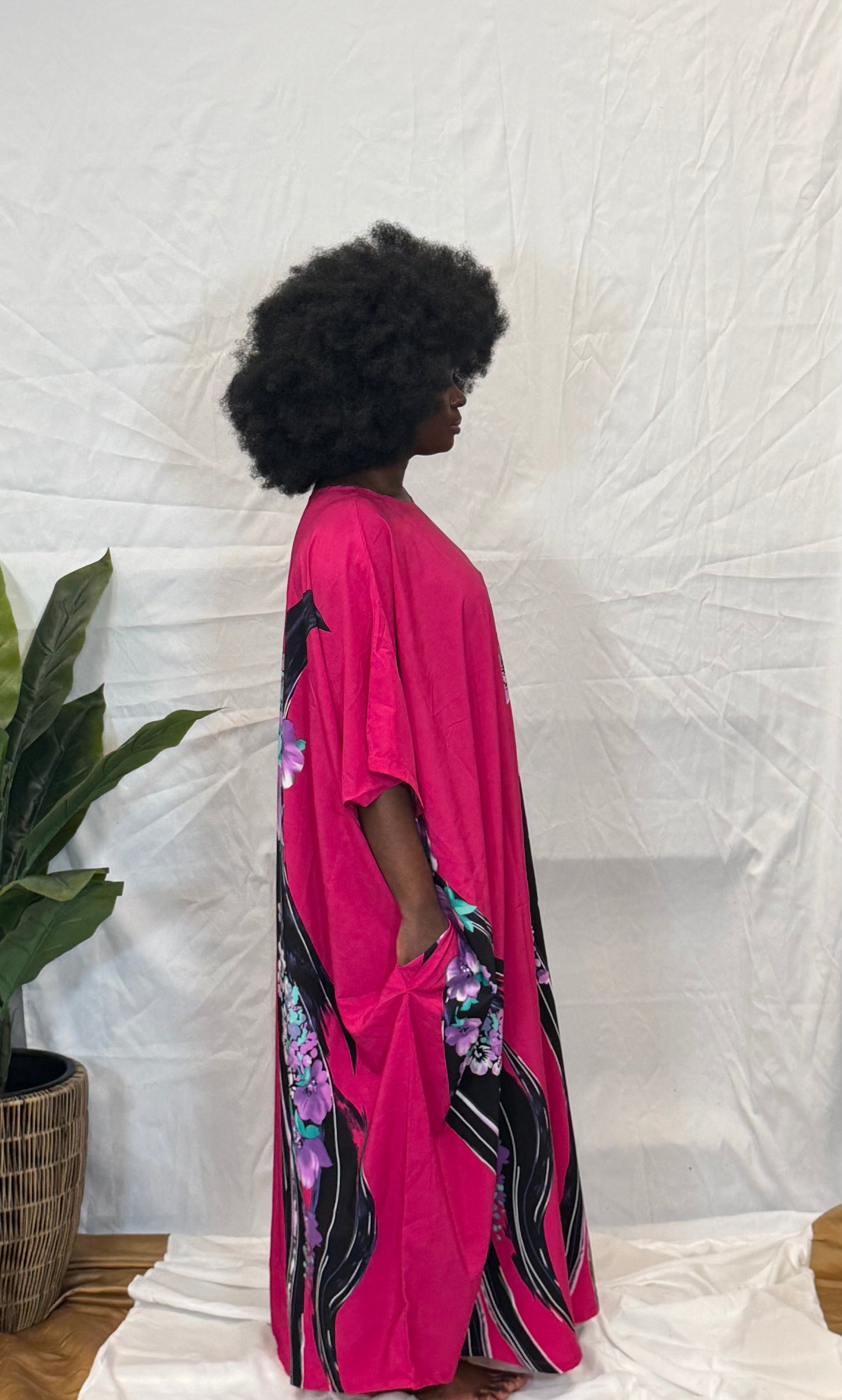 Black woman wearing bright colorful kaftan