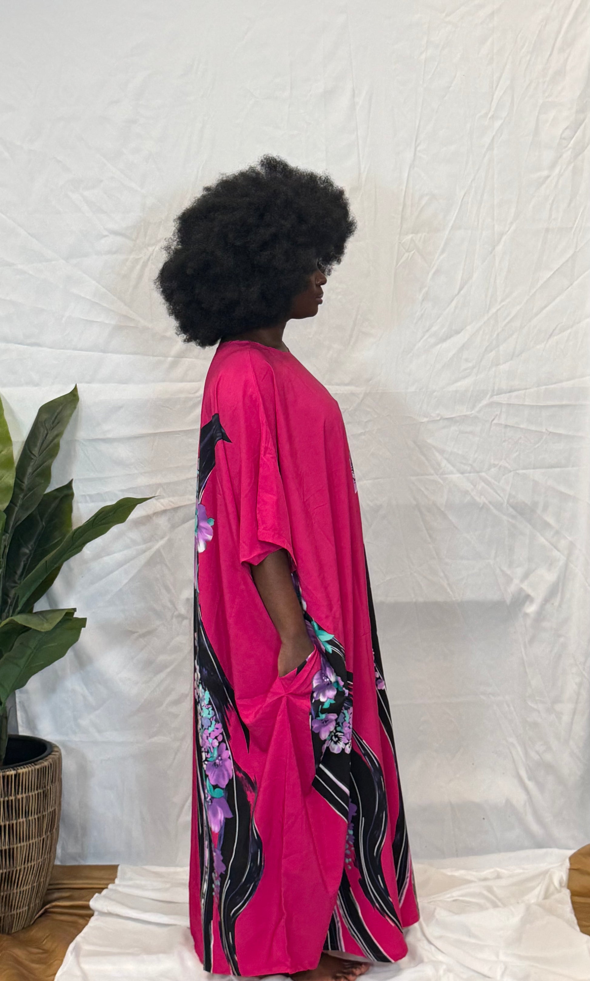 Black woman wearing bright colorful kaftan