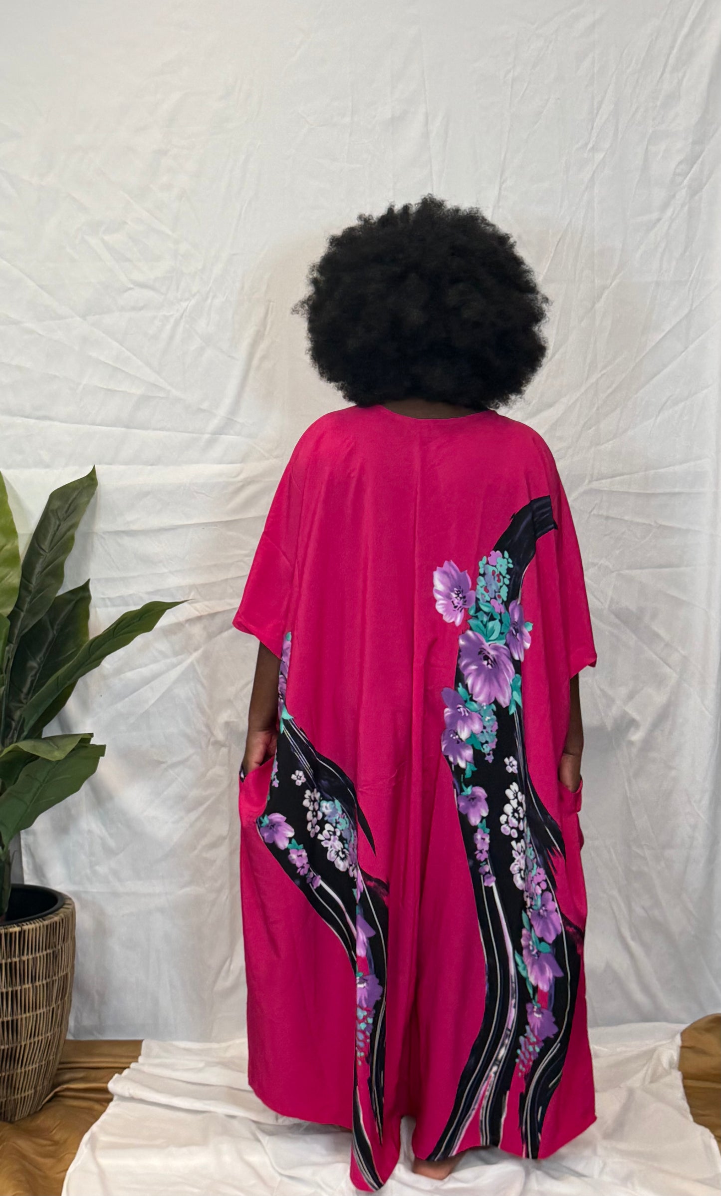 Black woman wearing bright colorful kaftan