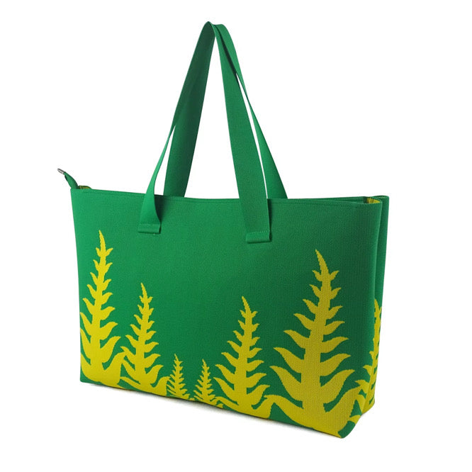 Green tote bag with yellow leaf pattern on a white background